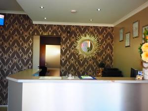 an office with a reception desk and a mirror at Bella Vista Motel in Gosford