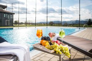 a table topped with a basket filled with fruit at Theodora Golf Club in Alba Iulia