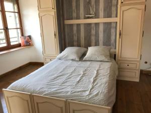 a bedroom with a large bed with two pillows at La chouette au bouleau in Hargnies