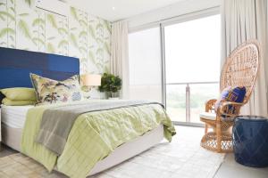 a bedroom with a bed and a large window at 55 Zimbali wedge Ballito in Ballito +24 photos