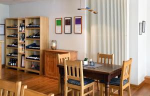 a dining room with a wooden table and chairs at Weingut Weich in Riol