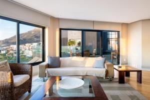 a living room with a couch and a table at Houghton View 13 Luxury Apartments in Cape Town