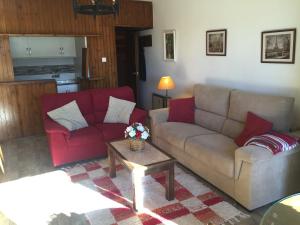 a living room with two couches and a coffee table at Apartment Plaza de Pradollano in Sierra Nevada