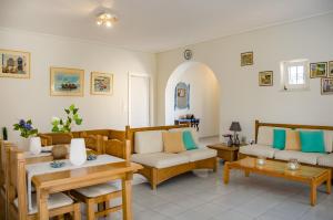 a living room with couches and tables at Villa Georgia in Vasilikos