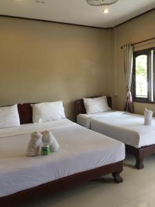 מיטה או מיטות בחדר ב-Lebijou Guesthouse - Konesavath