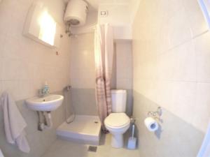 a small bathroom with a toilet and a sink at Studios Arabas in Thessaloniki