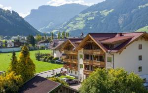 a view of a building with mountains in the background at Ferienhotel Sonnenhof in Zell am Ziller