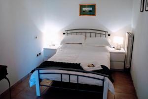 a bedroom with a white bed with a blue frame at Apricot House in Roccascalegna