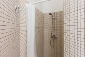 a bathroom with a shower with a shower curtain at Villa Ferreri in Specchiolla  +35 photos