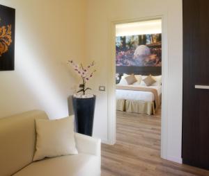 a room with a couch and a bedroom with a bed at Hotel Life in Rimini