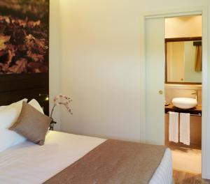 a bedroom with a bed with a mirror and a sink at Hotel Life in Rimini