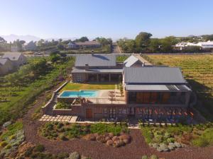 an aerial view of a house with a swimming pool at Vineyard Views Country House in Riebeek-Kasteel