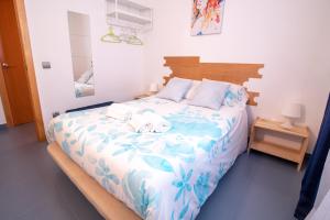 a bedroom with a bed with two towels on it at Hogar Vera Apartments&Bikes in Valencia