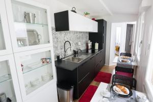 a small kitchen with a sink and a counter at Casa Pepe Via Fuoro in Sorrento
