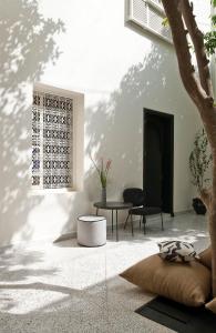 a living room with a tree and a table at Numa Marrakech in Marrakesh