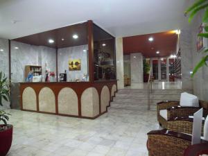 a lobby with a counter and chairs in a building at Apartamentos Jardins da Rocha in Portimão +37 photos