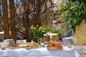 ポルトフェッラーイオにあるHotel Danilaの白いテーブルクロスと食べ物
