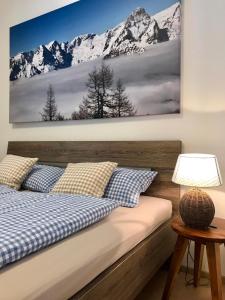 a bedroom with a bed with snow capped mountains at Urlaubsapartments Pfleger in Hinterstoder