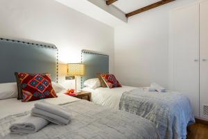 グラナダにあるGenteel Home Bib Ramblaのベッドルーム(ベッド2台、ランプ付)