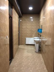 a bathroom with a sink and a toilet in it at Chabarukhi in Passanauri +73 photos