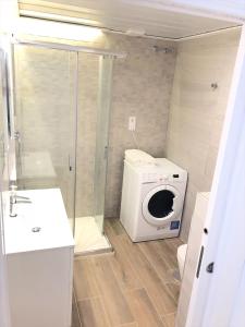 a bathroom with a washing machine and a washer at Apartamentos La Gloria in Benidorm +16 photos