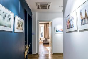 a hallway with paintings on the walls at OTTO Rooms & Photogallery in Rome