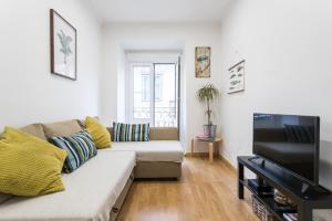 
a living room filled with furniture and a tv at Apartments Center Bairro Alto in Lisbon
