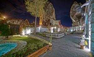 a house with a swimming pool at night at Anatolian Houses Cave Hotel & SPA in Goreme