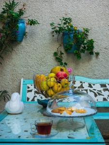 a table with a bowl of fruit and a plate of food at Peri Art Hotel in Alaçatı