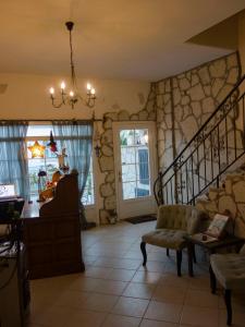 a living room with a staircase and a chair at Peri Art Hotel in Alaçatı