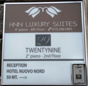 a sign for the hin luxury suites at a hotel at HNN Luxury Suites in Genova
