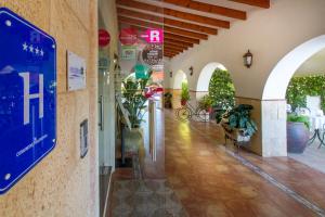 a hallway of a building with signs on the wall at Hotel Tossal d'Altea in Altea