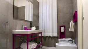 a bathroom with a white sink and a toilet at Hotel San Crispino in Morrovalle +38 photos