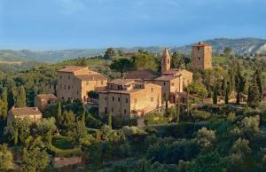 an old italian village on a hill with trees at Hapimag Resort Tonda in Montaione