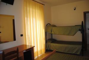 a bedroom with two bunk beds and a mirror at B&B Atlantide in Cagnano Varano