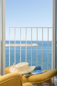 a hat sitting on a table in front of a window at Santa Maria 24 in Monopoli