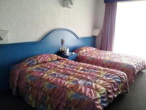 Una cama o camas en una habitación de Hotel Inn Sur