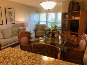 a living room with a table and a couch at Casitas Coral Ridge in Fort Lauderdale