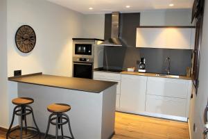 a kitchen with a counter and two stools at Casa Perez in Yebra de Basa