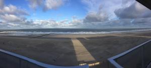 a view of a beach with the ocean and clouds at Apartment Mirador 6 in Blankenberge