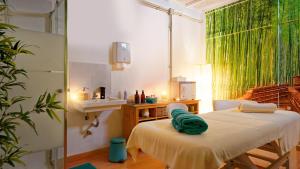 a room with a bed and a sink and a mirror at FBC Fortuny Resort - Adults Only in Maspalomas