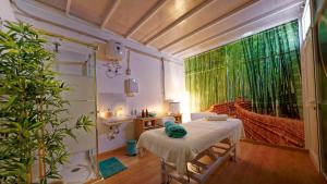 a small room with a bed and a large window at FBC Fortuny Resort - Adults Only in Maspalomas