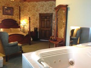 a bathroom with a tub and a bedroom with a bed at Afton House Inn in Afton +89 photos