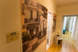 a hallway with a large painting on the wall at Le Affacciate Bruzie Home Guest House in Cosenza