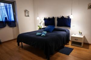 a bedroom with a large bed with blue pillows at I Colori di Mag in La Spezia