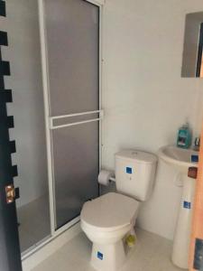 a small bathroom with a toilet and a shower at Hotel Mirador de Santa Bárbara in Socorro