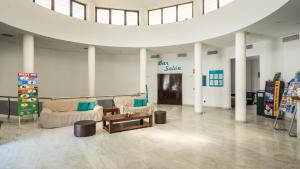 a lobby with couches and a table in a building at BLUESEA Costa Teguise Gardens in Costa Teguise +18 photos