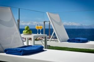 two chairs and a glass of wine on a balcony at Flamingo Beach Mate in Adeje
