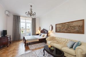 a living room with a couch and a table at LUXOVSKI apartment in Lviv
