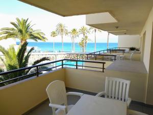 a balcony with chairs and a view of the ocean at Apartamentos Jet - Adults Only in Playa d'en Bossa
